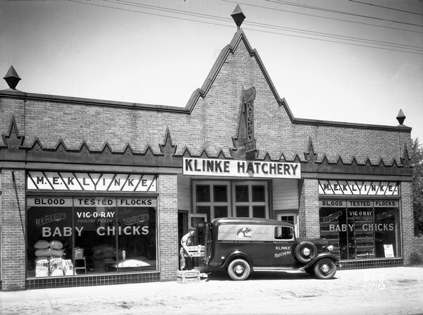 Klinke Hatchery, 1918 Winnebago Street, with an employee loading crates into the back of the company truck.