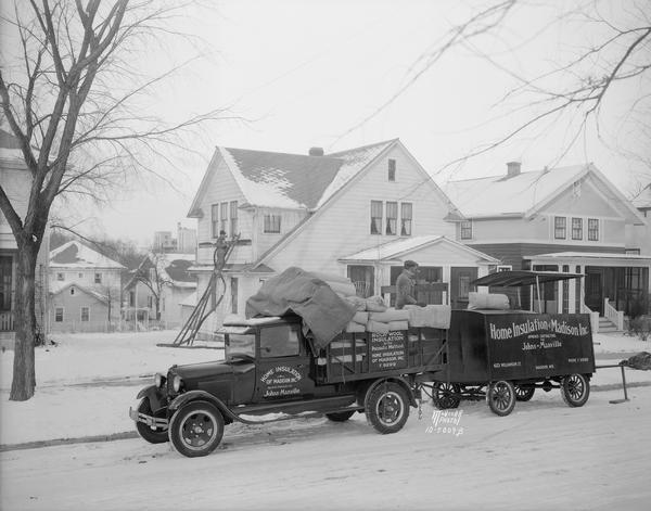 Two men and Home Insulation of Madison, Inc. truck in front of W.J. Sheppard, 2524 Chamberlain Avenue, house, shown installing Johns Manville rock-wool insulation.