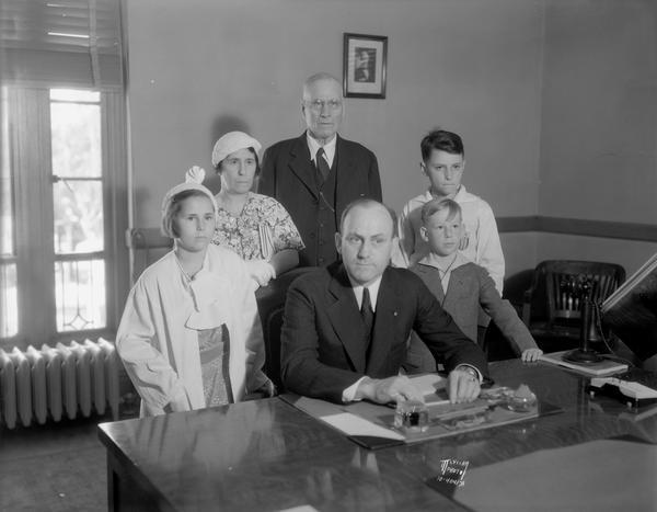 Group portrait of U.S. District Court Judge Patrick T. Stone, sitting, and behind him standing is, left to right is: daughter Mary Louise Stone, Mrs. Patrick T. Stone, father P.E. Stone, son Louis Owen Stone, and Paul O'Brien, friend of Louis.