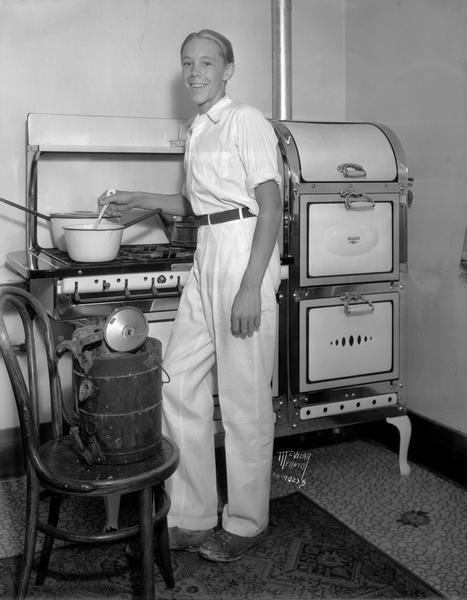 Steve Bradley cooking on a Reliable stove, with an ice cream maker (?) in the foreground.
