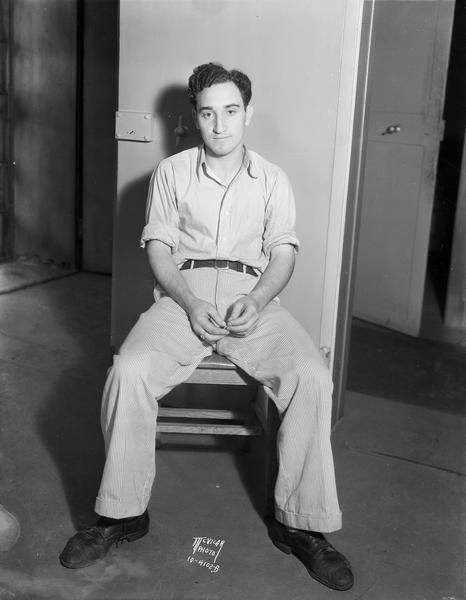 Portrait of Cecil LaValla, sitting in a chair at the county jail, suspect in the murder of Odin Tofsrud.