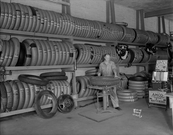A worker fixing a tire in front of racks of Gillette tires in the  Licari garage, 767 W. Washington Avenue, in the Greenbush neighborhood.