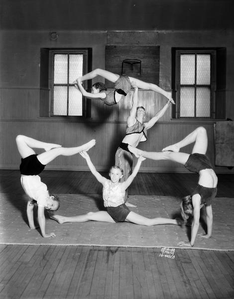 Madison Turnverein acrobats/gymnasts posing in an adagio formation, tutored by J.C. Haberman, at Madison Turner Hall, located at 21 South Butler Street.