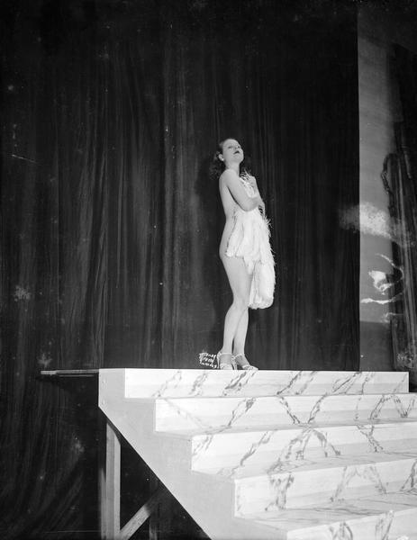 Fan dancer Rosita Carmen performing at the Orpheum Theatre, while offstage she is accompanied by the organist Mac Bridwell.
