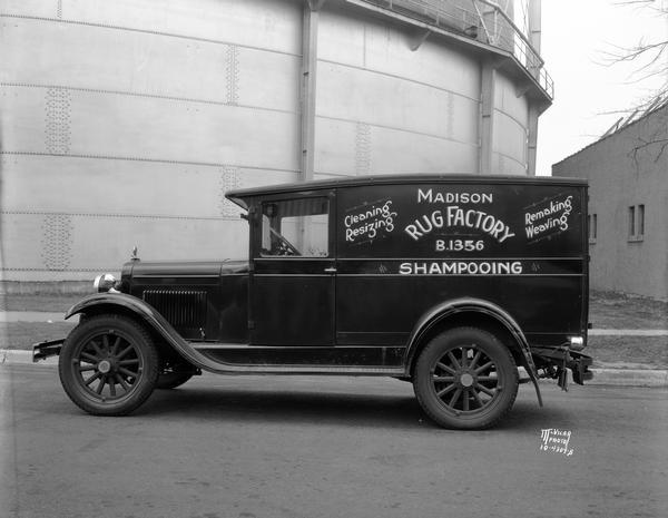 Company truck for the Madison Rug Factory at 8 S. Livingston Street, with advertising for cleaning, resizing, remaking, weaving, and shampooing services.