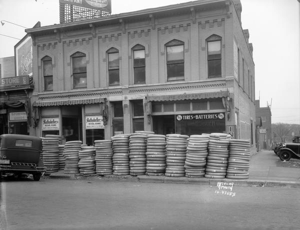 G and E Store, Tires and Batteries, 124 E. Washington Avenue, with piles of tires on the sidewalk and the Rathskeller Retail Store, 124 E. Washington Avenue, liquor store next door.