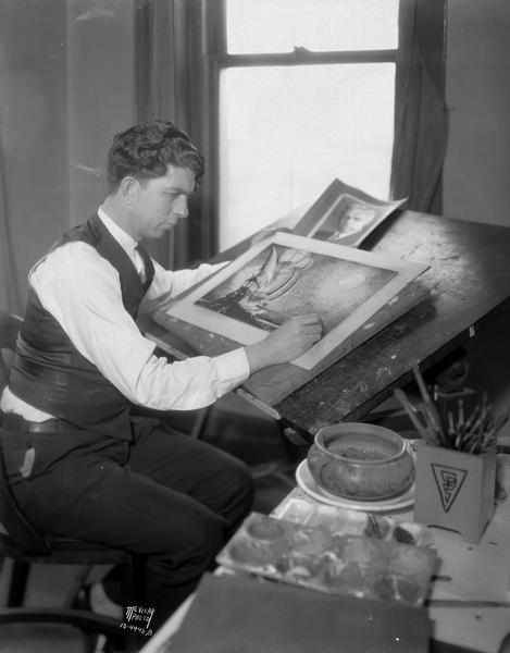 Chauncey D. Stewart, commercial artist on the staff of Wisconsin Engraving Co., 109 S. Carroll Street. He is at work on an illustration from which an engraving will be made.