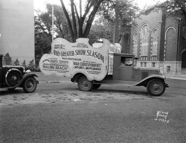 "RKO Greater Show Season" promotional truck with calliope, and signs advertising Raquel Torres in Fanchon and Marco's "Malibu Beach" and Jack Holt and Ralph Graves in "War Correspondent" at the RKO Orpheum Theatre.