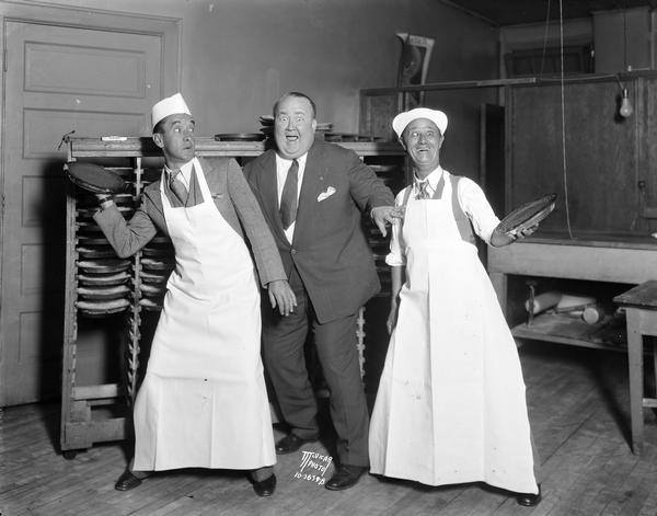 Snub Pollard, Walter Hiers, and Ben Turpin, about to throw pies at Bjelde's Pie Shop, located at 302 North Francis Street.