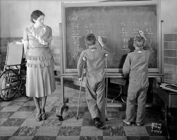 Teacher and two students at the blackboard in the Wisconsin Orthopedic Hospital for Children, University of Wisconsin, 436 N. Randall Street.