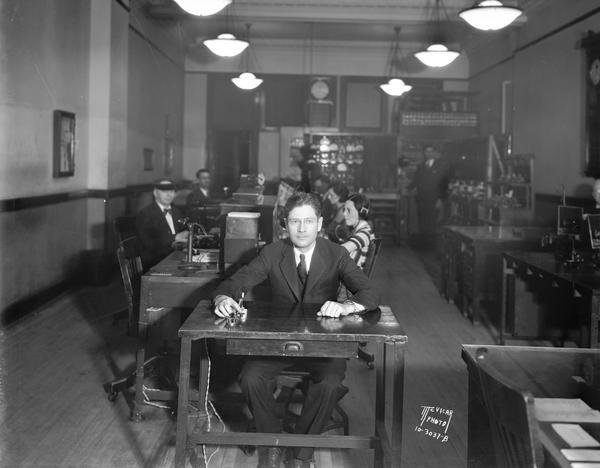 Governor Philip F. La Follette presses a telegraph key at the Western Union Office to open an event in Green Bay.