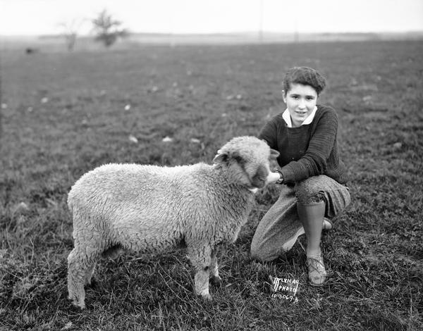 Marian Dolan of the Maple Knoll 4-H club north of Sun Prairie, 1931 National 4-H champion, showing her lamb.