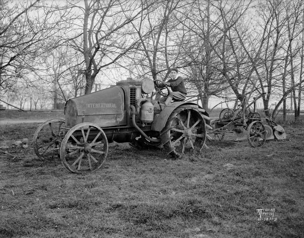 Marian Dolan of the Maple Knoll 4-H Club north of Sun Prairie, 1931 National 4-H champion, driving an International tractor.