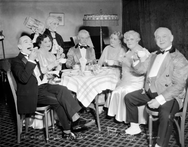 Aunt Mary putting on a "Corn-top Bread" lunch in the Orpheum Theatre N.U.A. room. Seated left to right: Dave Genaro, Lizzy Wilson, Tom Harris, Annie Hart, Josephine Sabel, and Danny Simmons. Standing in the rear is Aunt Mary.