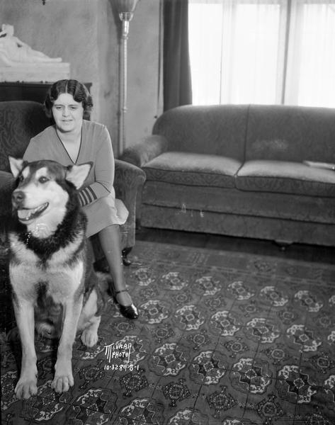 Thea Hobson, 1922 Jefferson Street with "Kinok," her Alaskan huskie, in the living room.
