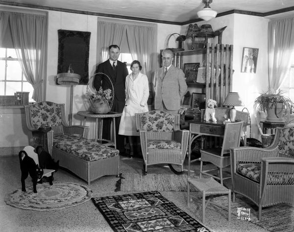 Handicrafts, including wicker furniture and rugs on display at the sales display room in Wisconsin Memorial Hospital, on Farwell Point, adjoining Mendota Mental Health Hospital. The crafts were made by recovering mentally ill soldiers. Left to right, Frank Nieman, Director of Occupational Therapy, Mrs. Nieman, assistant, and Dr. H.C. Werner, hospital superintendent.