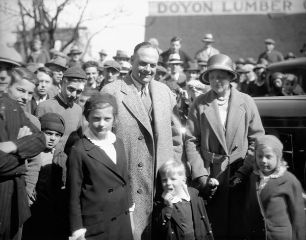 Dr. Clarence W. "Doc" Spears, the new University of Wisconsin football coach, with his wife and their three children being greeted by a crowd.