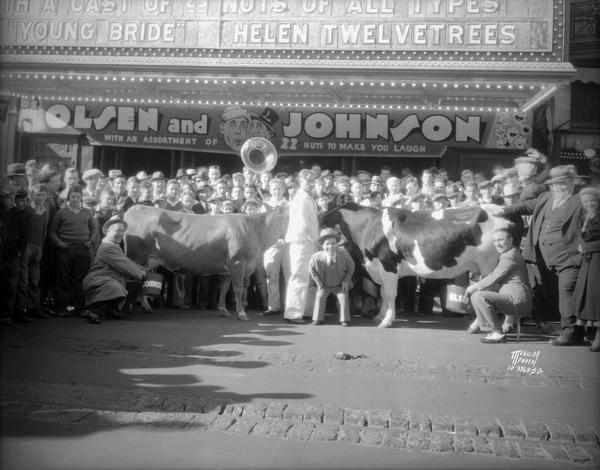 Olson & Johnson milking cows in front of the Orpheum Theatre, 216 State Street, promoting their show "Atrocities of 1932."