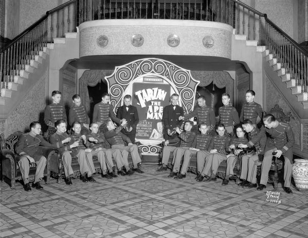 Orpheum and Capitol ushers relaxing at the Orpheum Theatre, 216 State Street, where "Tarzan the Ape Man" is showing, at a kickoff for the Milk Bottle Fund to purchase tigers for Vilas Zoo (Vilas Park Zoo).