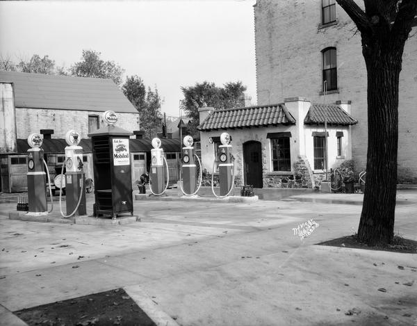 View of Mobiloil gas pumps at the Simon Hotel Service Station, located at 107-113 South Butler Street.