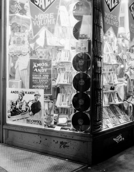F&W Grand store window, located at 15 W. Main Street, displays 33 rpm records, jewelry, and advertising for Amos n' Andy in the film "Check and Double Check."
