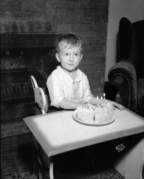 Portrait of Richard McVicar with his birthday cake and candles on his fourth birthday.