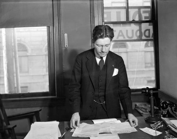 Governor-elect Philip F. La Follette reading a telegram at the La Follette campaign headquarters.