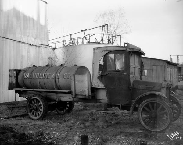 A Valvoline Oil Company tank truck made by Diamond T is parked awaiting a job.
