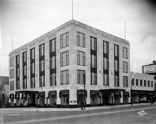 View of Harry S. Manchester's Inc. department store with display windows and awnings over the entrances, on the corner at 2-6 East Mifflin Street.