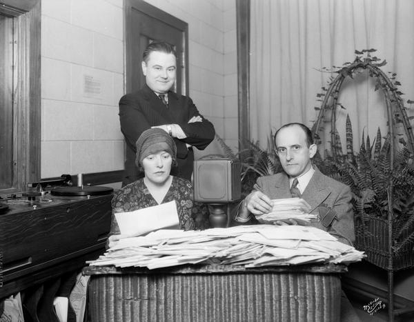 WIBA "Mystic Myrah and Lorenz," seers, reading mail from listeners in the Fern room. Patrick Shannon from WIBA, observing.