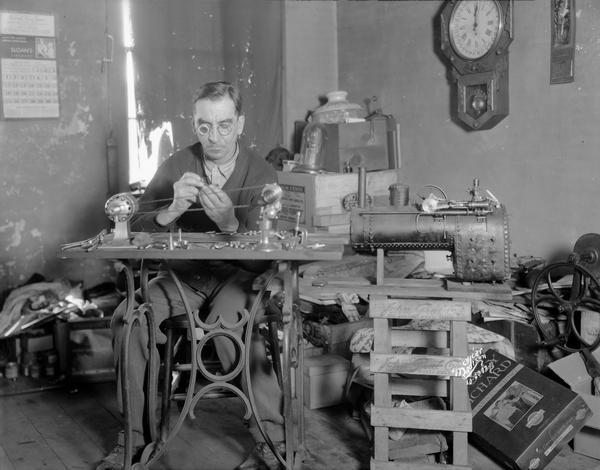 Nick Knechtges, watchmaker, at his workbench in his home shop.