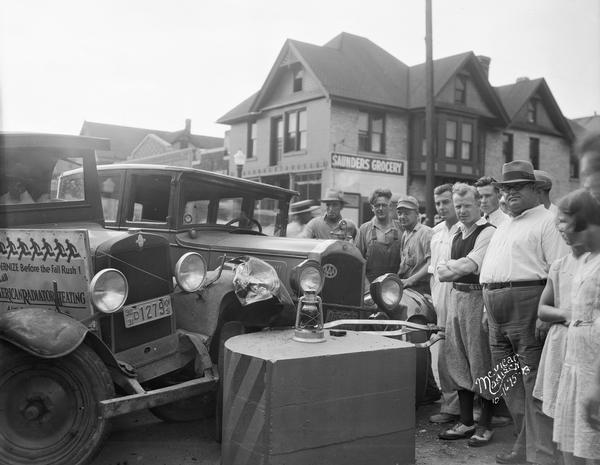 A crowd of people gathered at an accident between a Hooper truck and a Willys-Knight automobile at a safety island at University Avenue and Murray Street.