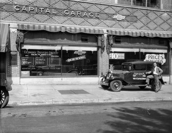 Lyman Sylvester of 1818 Keyes Avenue, the winner of the automobile economy driving contest, stands next to a Chevrolet Six automobile outside Hult's Capital Garage, 608-612 East Washington Avenue.