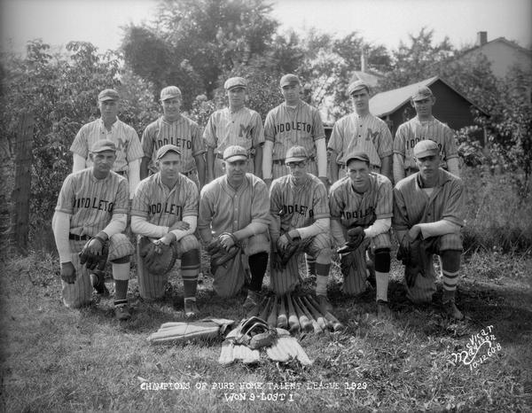 Players of the 1929 Middleton baseball team, champions of the Pure Home Talent league, posing for a group portrait in uniform with bats and other baseball equipment. The team won 9, lost 1.  