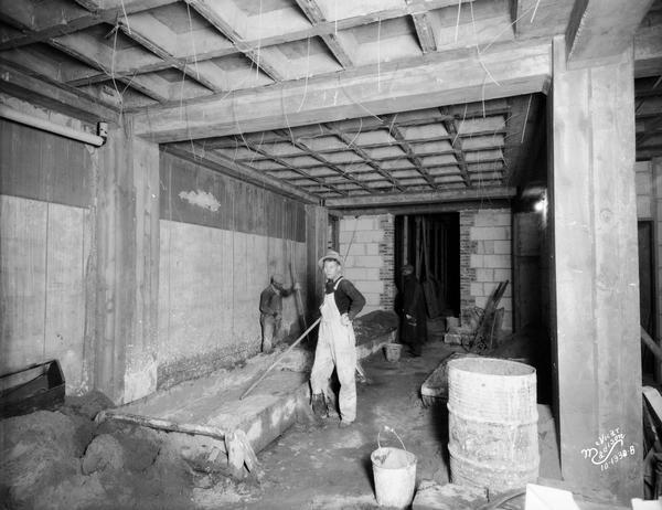 Workmen inside a new corridor addition under construction in the State Bank of Wisconsin, 1 West Main Street.