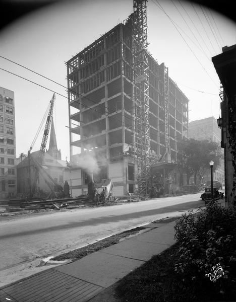 A crane and other machinery are used in the construction of the Wisconsin Power and Light building, 122 West Washington Avenue.