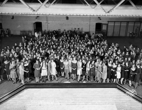 Group portrait of the Central High School Girl's Club having a party in the gym.