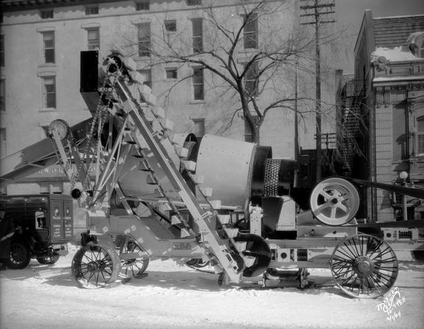 A crushing machine is displayed as part of a Wisconsin Foundry & Machine Company road equipment exhibit on Monona Avenue (Martin Luther King Blvd.).