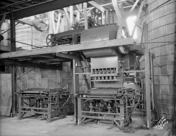 View of a machine that makes concrete blocks at Madison Silo Company.