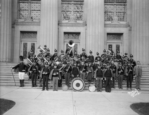 Musicians from the Central High School marching band posing outdoors in uniform with their instruments.