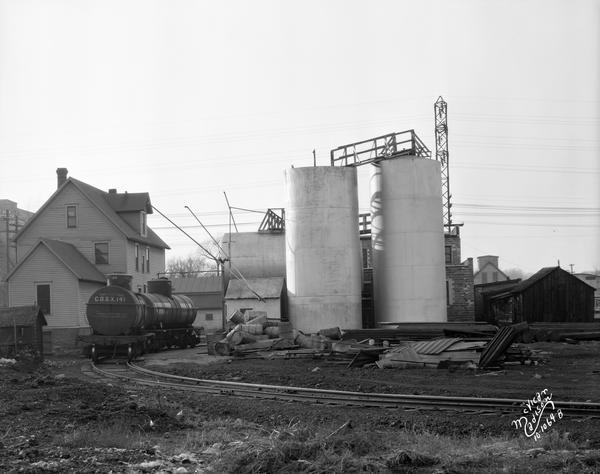 A railroad tanker car is sitting on tracks next to fuel storage tanks at the Capitol Oil Company, 919 East Main Street.