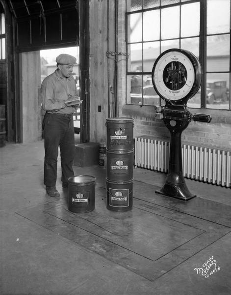 Man weighing Mautz paint pails at Mautz Paint Company with a new Toledo scale.