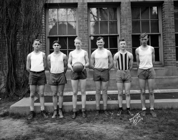 Outdoor group portrait of the Central High School male senior class basketball team.