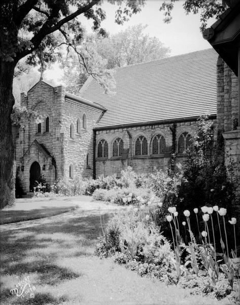 View of the garden and lawn next to the side entrance of Calvary Lutheran Center, 713 State Street. The original St. Paul's nave survives behind both Calvary Lutheran and the University Book Store.
