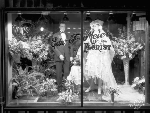 Bride and groom mannequins with floral displays in Edward F. Meier Inc. Florist "bridal window," 542 West Washington Avenue.