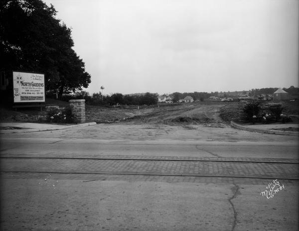 Front view of the entrance to the North Gardens subdivision, on the corner of North Street and Hoard Street, owned by the Paul E. Stark Company. The stone pillars are no longer standing.