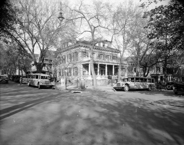 Phi Gamma Delta fraternity house, located at 521 North Henry Street, with Royal Rapid Transit Co. buses.