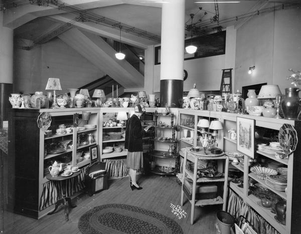 View of the Kessenich's Gift Shop, located at 201 State Street, with a woman customer standing among the display shelves.