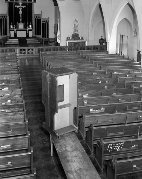 Elevated view of a portable confessional on a table in the center aisle of Blessed Sacrament Catholic Church, 2119 Rowley Avenue.