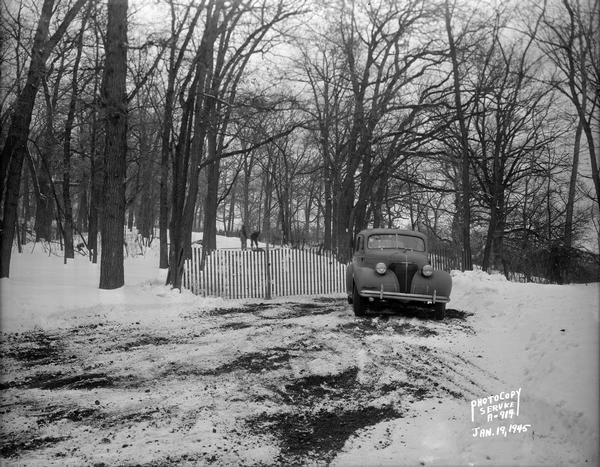 Winter scene with automobile parked in front of barricade at west end of Edgewood Drive.